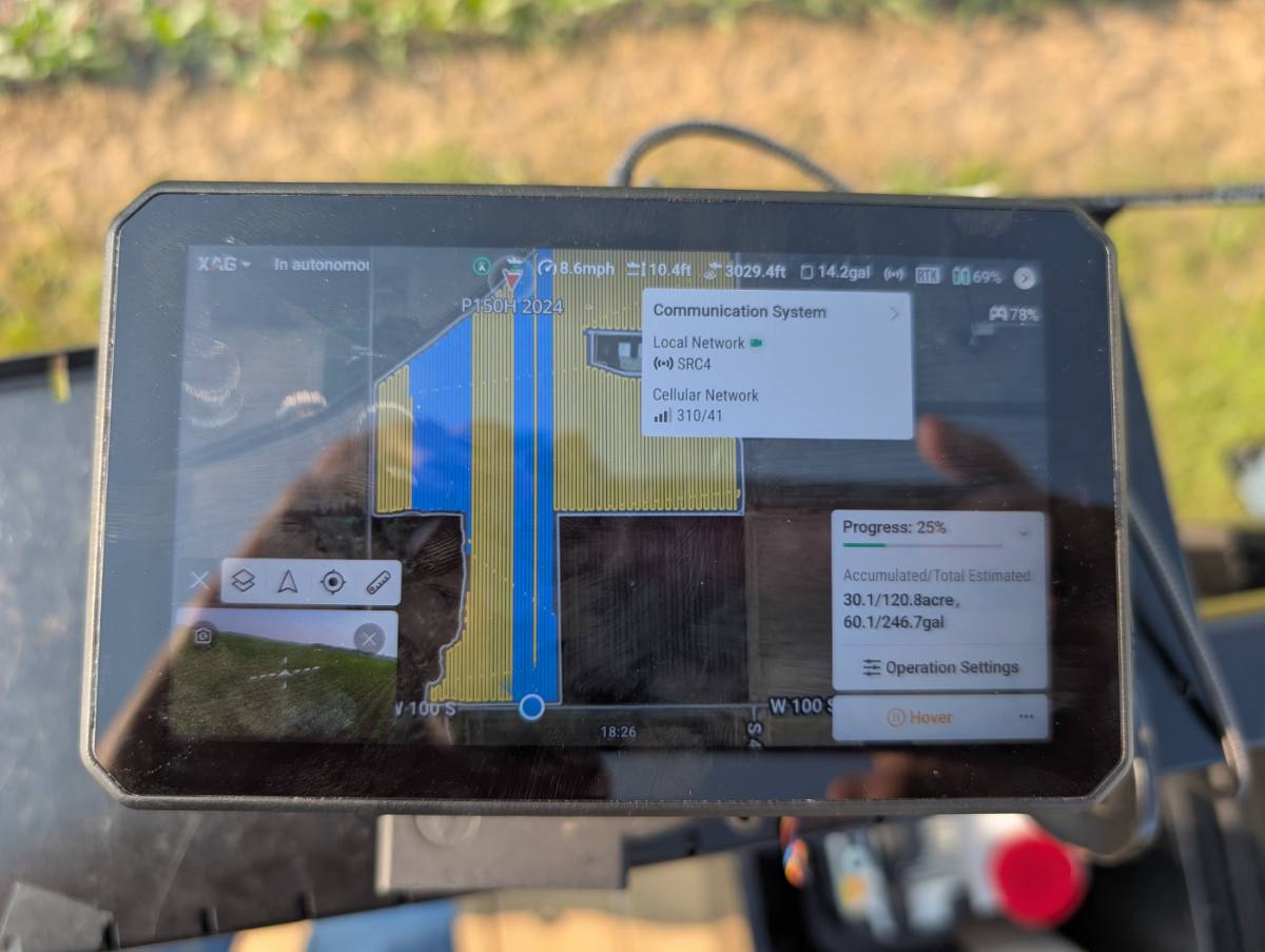 Technician monitoring an autonomous spray mission on the controller